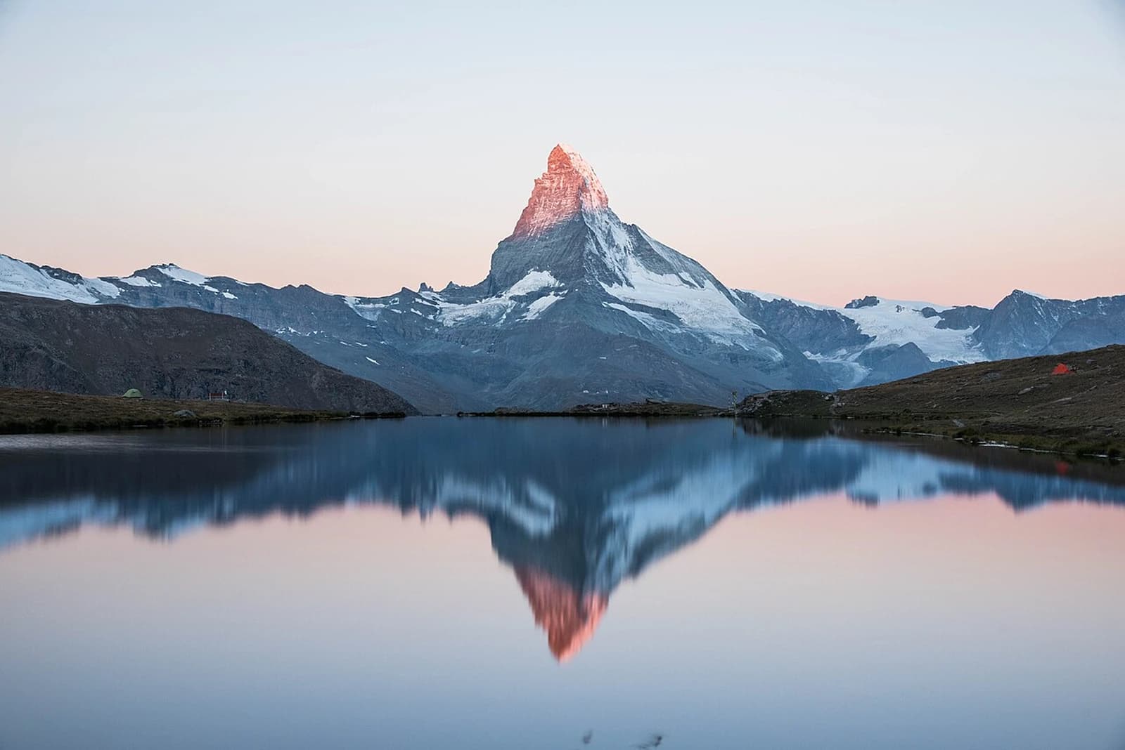 The Matterhorn rising above an alpine village at sunrise, Switzerland