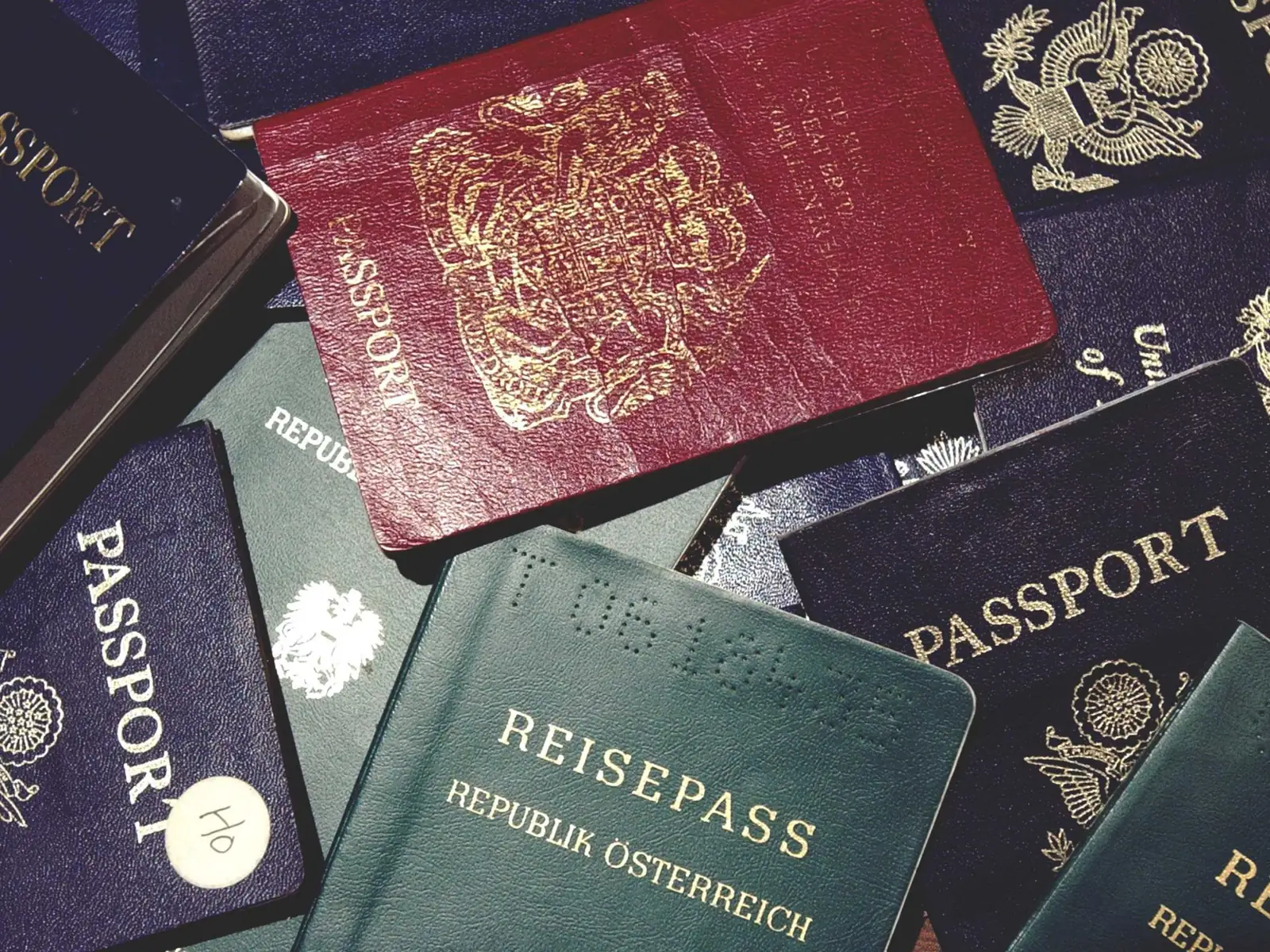 Hands stamping and organising attested certificates and translated documents on a desk